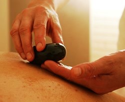 Carlisle Pennsylvania massage therapist holding hot stone